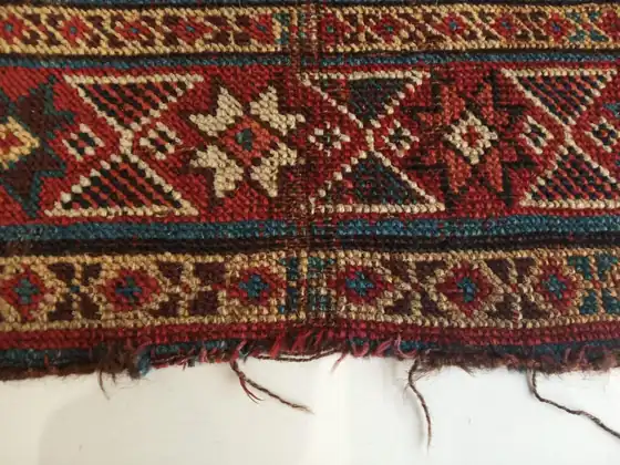 Extrémité effrangée, avant reprise des franges.